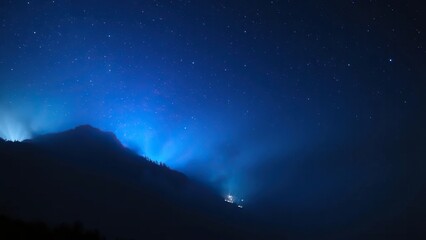 Obraz premium Blue starlight casting an ethereal glow on misty mountainside, blue light, glowing
