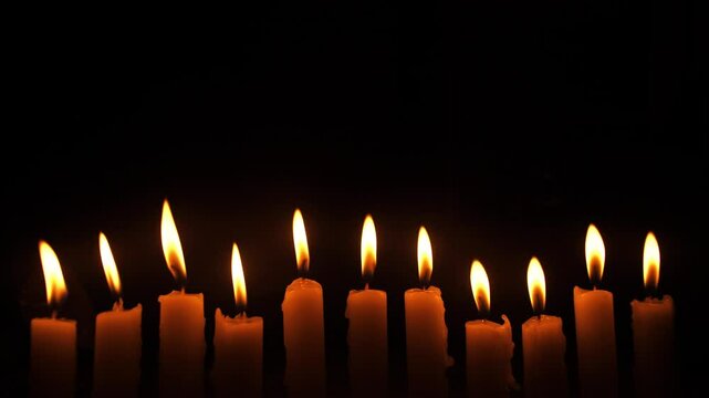 set of candles timelapse on a black background