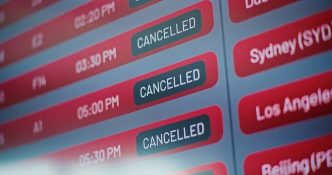 International Airport Terminal: Close Up of Digital Arrival and Departure Information Display Showing Flight Data For Travelers. Cancelled Flights Due to Bad Weather Conditions or Terrorist Attack.