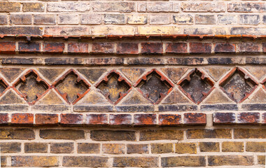 Beautiful ancient texture of carved red bricks
