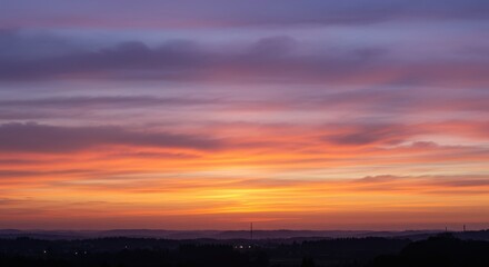 Fototapeta premium Breathtaking sunset over rolling hills with vibrant colors and serene landscape