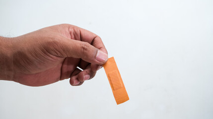 man holding bandage or plester, isolated on white background
