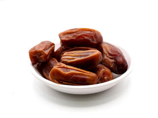 Tunisian dates on a white bowl isolated on a clean white background