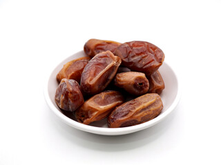 A stack of Tunisian dates on a white bowl isolated on a clean white background