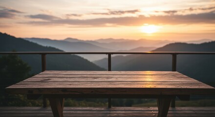 Serene sunset view from a wooden table overlooking misty mountains