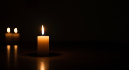 Softly glowing candlelight illuminating a dark room, creating a serene atmosphere