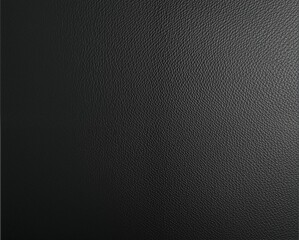 Obraz premium A textured black surface that appears to be leather, showcasing a rich, deep color with a subtle pattern.