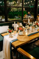 Woodland-Inspired Indoor Banquet with Green Chairs and Romantic Candle Light