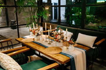Soft Candle Light and Green Chairs Creating a Magical Indoor Wedding Setting