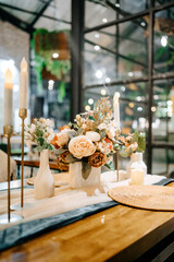 Rustic Indoor Banquet Hall with Green Chairs and Warm Candle Light Glow