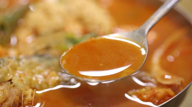 Spicy shaggy sea raven stew with a spoon