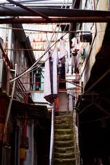 Georgian old house yard through an arch, lots of wires, clothes and linen drying on ropes. Batumi, Georgia