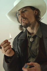 Brutal man dressed as cowboy lighting cigarette with match, gazing into distance, wearing leather...