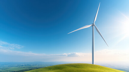 Obraz premium Aerial view of wind turbine on hill under clear blue sky, symbolizing renewable energy