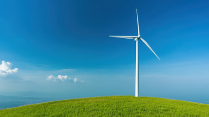 Obraz premium white wind turbine stands tall on green hilltop under blue sky