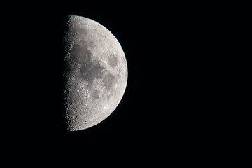 First Quarter moon against black sky