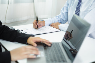 Business people hold a resume and talk to job applicants for job interviews about careers and Their personal history in the company. Recruitment concepts