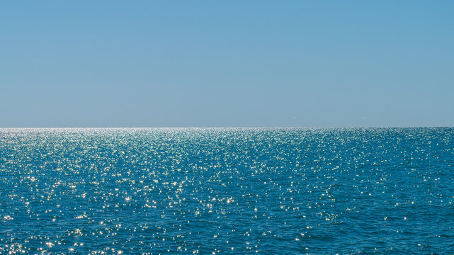 Lake Michigan on a clear day with rippled sparkling surface below clear blue sky