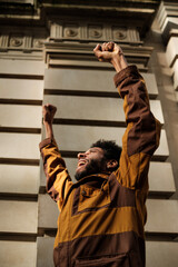 Young activist raising fists in protest, fighting for rights and equality