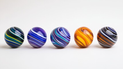 Five colorful marbles with swirling patterns arranged in a line on a clean surface