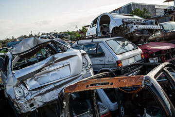 Chaotic pile of damaged and abandoned cars in a junkyard