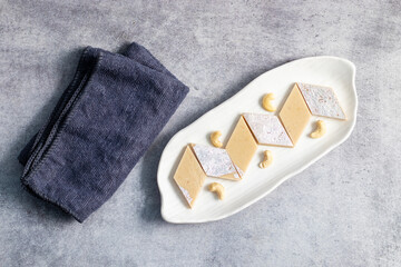 Kaju Katli is a rich, smooth Indian sweet made from cashew nuts, sugar, and ghee, delicately...