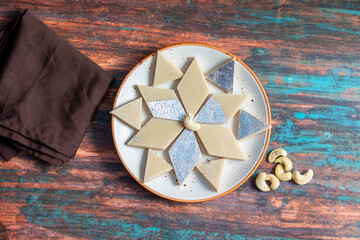 Kaju Katli is a rich, smooth Indian sweet made from cashew nuts, sugar, and ghee, delicately flavoured with cardamom and often adorned with silver leaf.