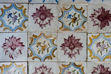 Scratched damaged tiles with floral ornate in Lisbon, Portugal. Vintage architecture