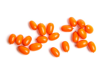 Scattered sea buckthorn berries with a vibrant orange color isolated on a white background. Fresh berries, top view, flat lay