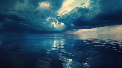 Obraz premium Dramatic dark stormy clouds over a calm tranquil ocean seascape