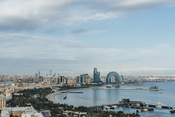 Fototapeta premium top panoramic view of baku city bay with huge area with buildings and parks around over cloudy sky