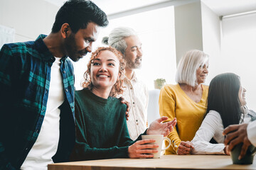 Happy people have fun in kitchen during lunch break. Happy friends celebrating together drinking coffee at home