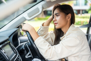 Driving during rush hour But the traffic is very congested. Angry face. Young asian businesswoman...