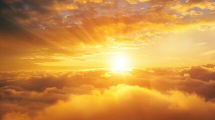 Obraz premium Golden Sunset Radiating Light Above a Sea of Clouds
