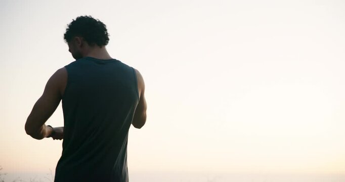 Happy man, fitness and winning with sky in nature for workout achievement, goals or success. Male person, athlete or runner with fist pump or watch for performance, exercise or training completion