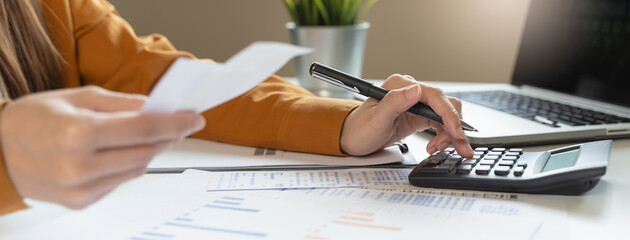 person using calculator calculating tax refund on the table
