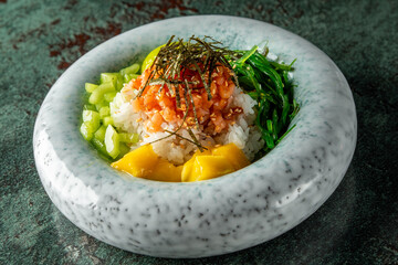 A beautifully arranged bowl of sushi rice topped with fresh vegetables, seafood, and garnished with seaweed, showcasing vibrant colors and textures.