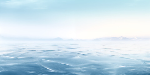Obraz premium A serene ocean view with gentle waves reflecting the soft blue sky at dawn.