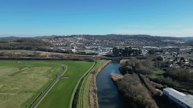 Newton Abbot, South Devon, England: DRONE VIEWS: The Town Quay bridge (Brunel Industrial Estate behind the bridge),  the racecourse, the River Teign and the mainline railway track (Clip 1).