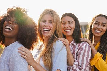 Group of young happy multiracial girls smiling on camera outdoor - Diverse women having fun...