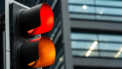 Red and amber traffic lights in an urban setting