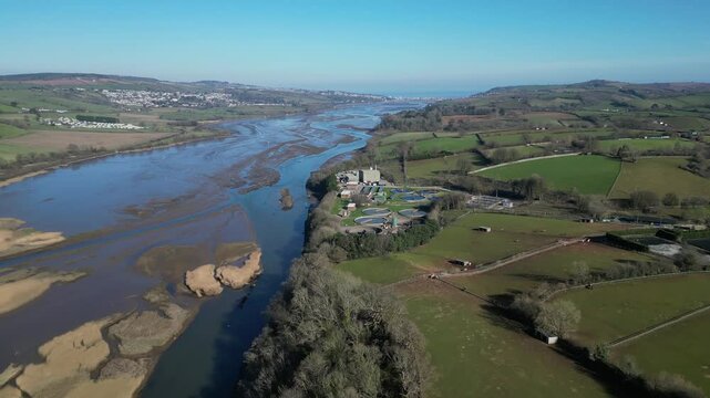 River Teign, South Devon, England: DRONE VIEWS: The drone reverses over the River Teign and A381 road bridge as traffic flows. South Devon is a popular UK holiday destination (Clip 3).