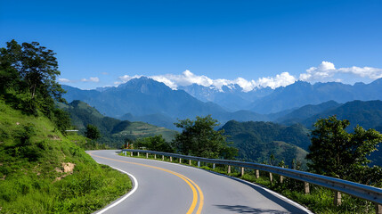 Obraz premium Winding Mountain Road Through Lush Green Hills Under a Bright Blue Sky