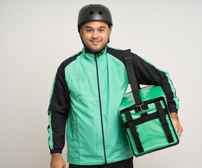 Young asian rider wearing green jacket uniform and bike helmet various action with delivery box. Male delivery service worker. Courier and shipping food service to customer online application