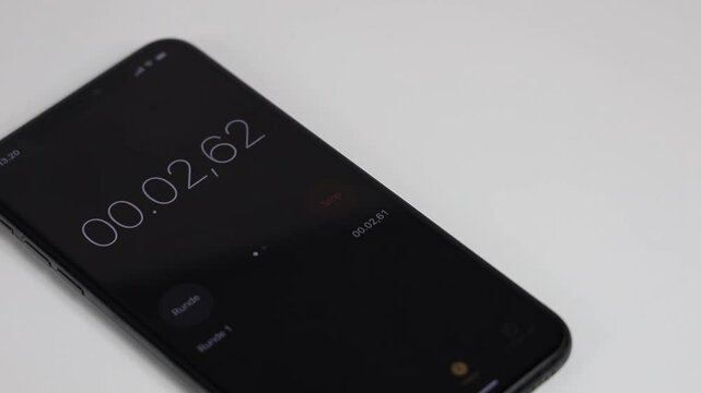 The stopwatch is running on the mobile phone screen