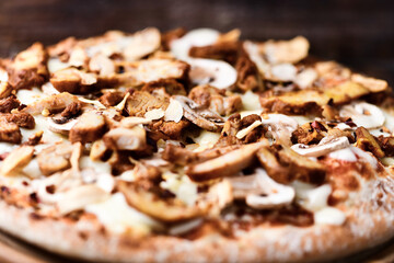Gyros Pizza with with champignons and mozzarella cheese. Wooden background. Soft focus.	