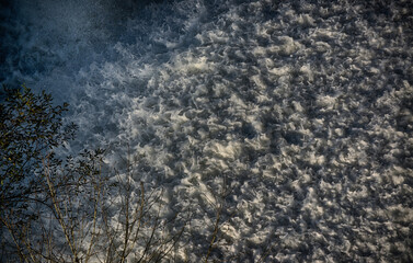 Water foam in a river waterfall