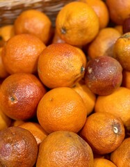 Box with ripe fresh organic tangerines on the shelf of a fruit supermarket are displayed for sale. Close-up