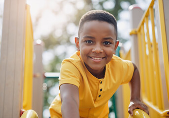 Portrait of a smiling boy having fun on a playground slide