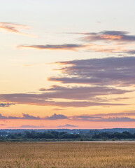 The sky is a beautiful orange color as the sun sets